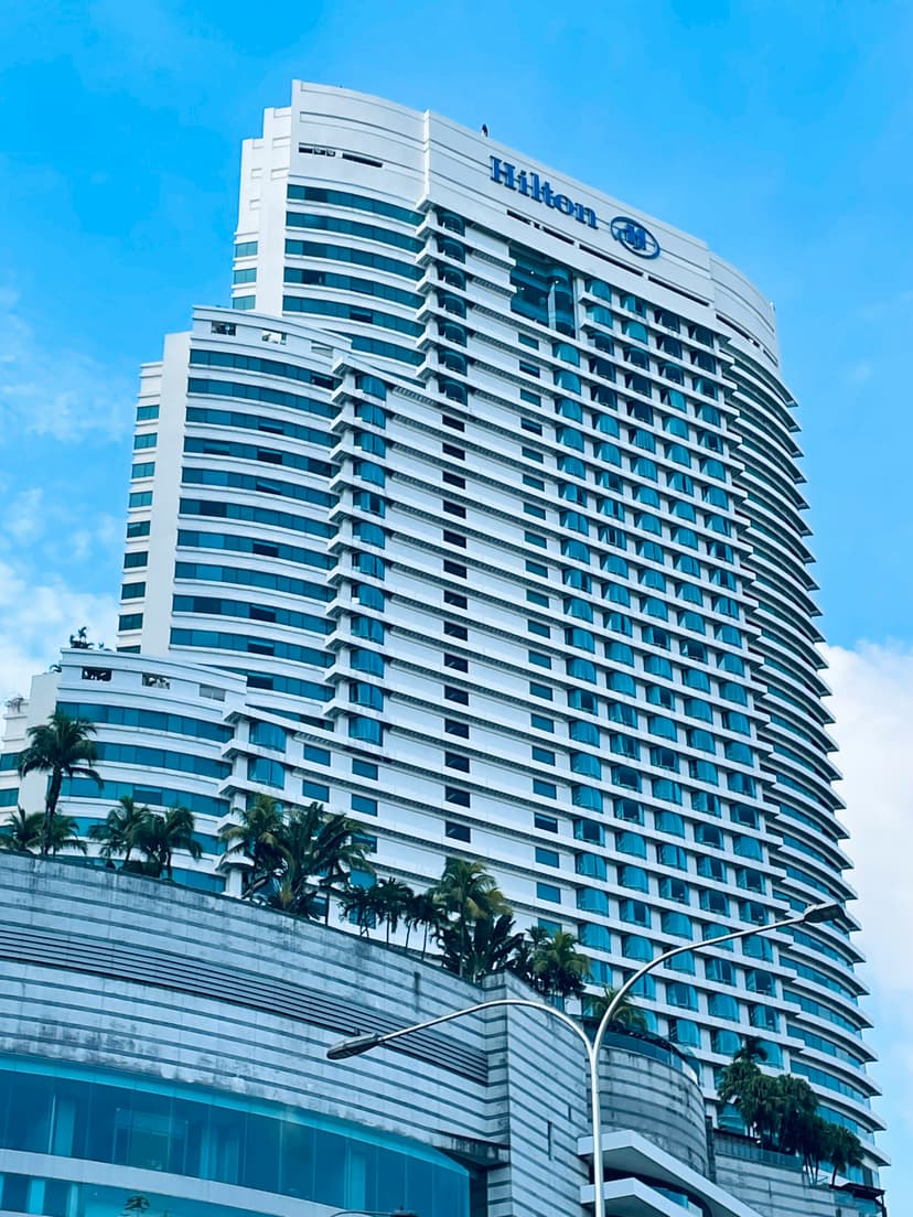Palm-lined entrance of a Miami Beach hotel resort with cars at valet