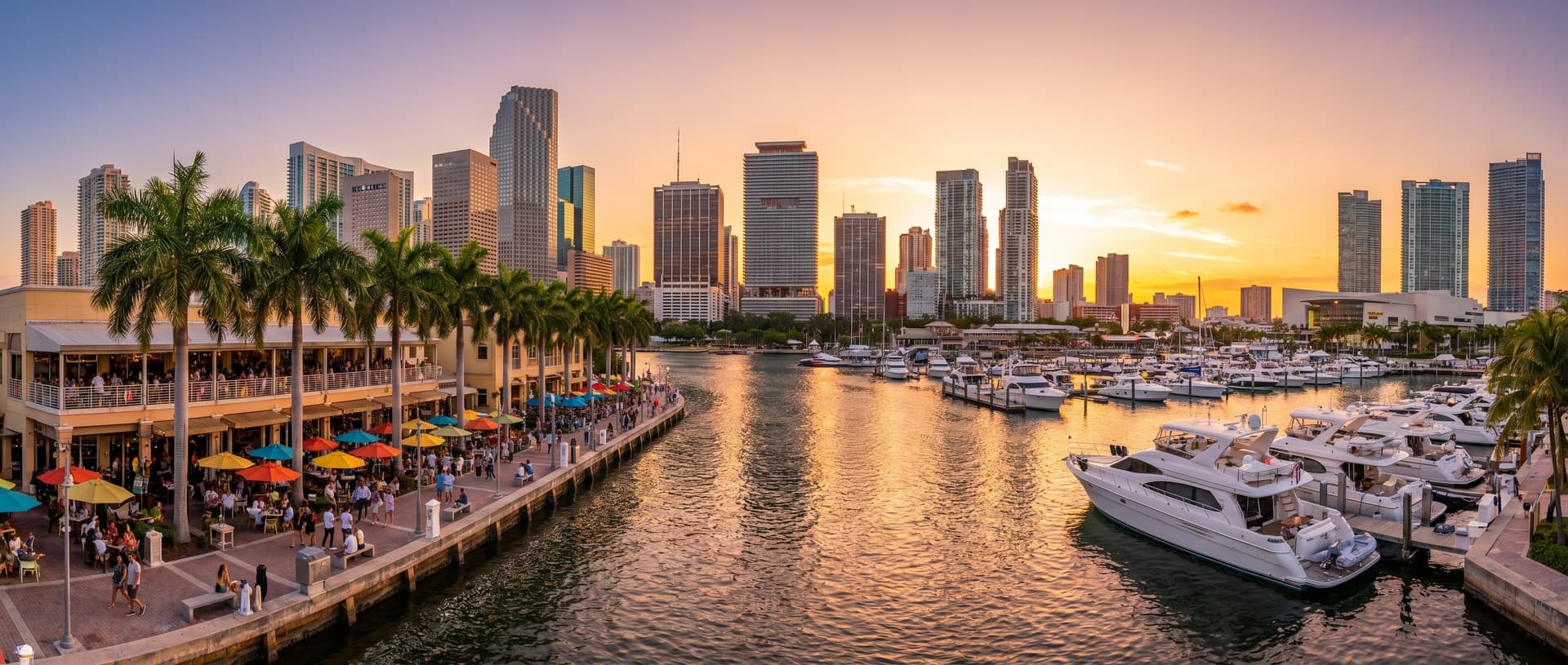 Panoramic view of the Miami River at golden hour with waterfront restaurants, docked yachts, and downtown skyscrapers reflecting warm sunset light